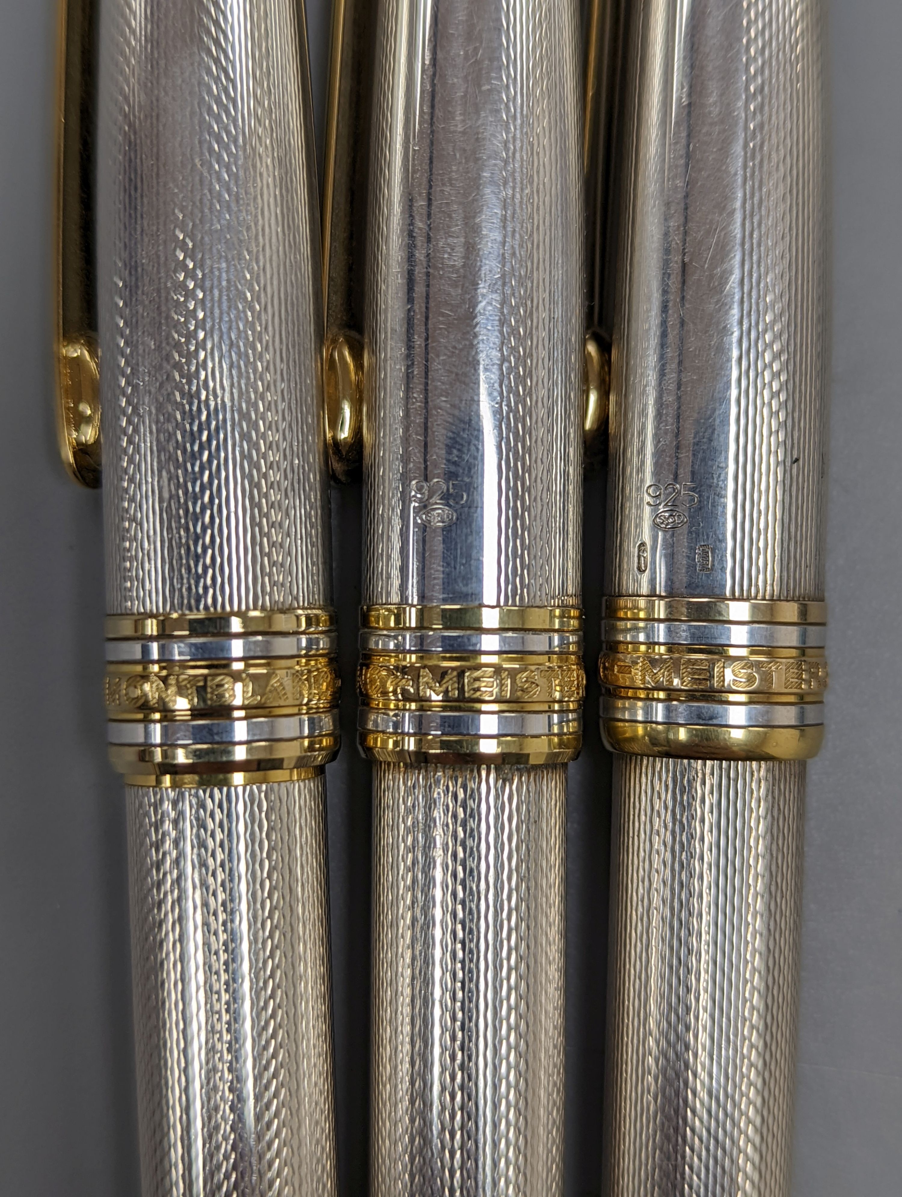 A modern suite of three silver Montblanc Meisterstuck ballpoint pens and pencil